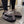 A lifestyle shot of someone wearing the slippers indoors, illustrating their versatility for both indoor and outdoor use. A promotional banner in the corner displays the offer for 50% off the second pair with code HALFOFF.