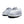 A close-up of a pair of unisex slippers featuring soft premium faux fur and local cotton. The rubber dot sole is clearly visible, emphasizing durability and grip. The slippers are displayed on a cozy rug.