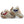 A close-up of a pair of unisex slippers featuring soft premium faux fur and local cotton. The rubber dot sole is clearly visible, emphasizing durability and grip. The slippers are displayed on a cozy rug.